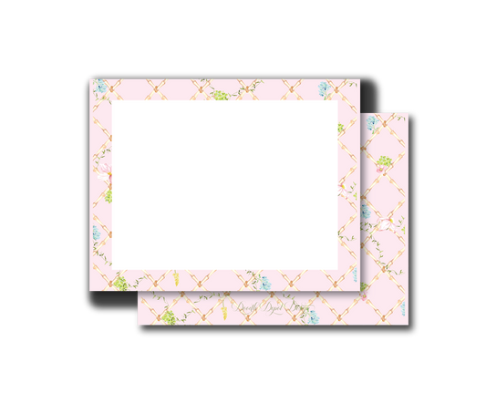 A set of two rectangular cards or envelopes with a light pink border featuring a gold lattice pattern and small pastel blue and green floral accents, displayed on a clean white background.