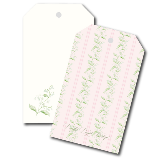 Two decorative gift tags with a lily of the valley floral design. One tag is plain cream with a small green floral print in the lower left and a hanging hole at the top.