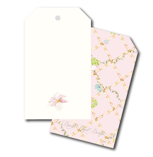 Two decorative gift tags with hanging holes, shown on a white background. The front tag is plain white with a small pale pink flower near the bottom.
