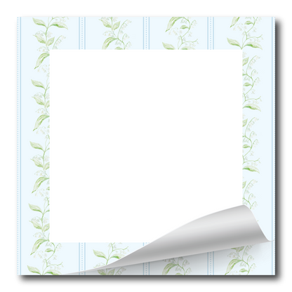 A square white paper notepad or stationery sheet with a decorative border of light green leafy vines around the edges and a curled bottom-right corner, shown on a white background.