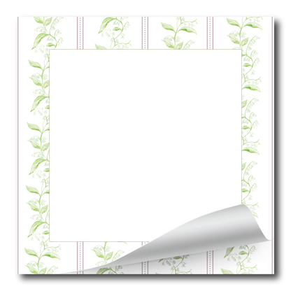 A square white notepad or memo pad with a decorative border of light green leafy vines and dotted lines, shown on a white background with one bottom corner curled up.