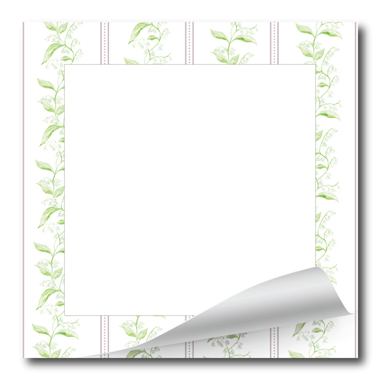 A square white notepad or memo pad with a decorative border of light green leafy vines and dotted lines, shown on a white background with one bottom corner curled up.