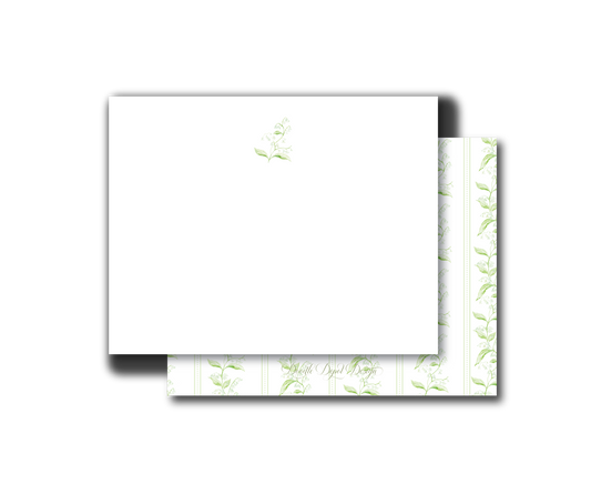 A stack of white stationery cards or envelopes with a delicate light green botanical pattern on the edges, shown on a plain white background.