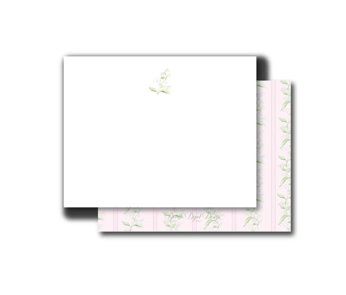 A white rectangular card or envelope with a small pale green floral print near the top, layered over a pink patterned sheet with repeating green botanical motifs, shown on a plain white background.